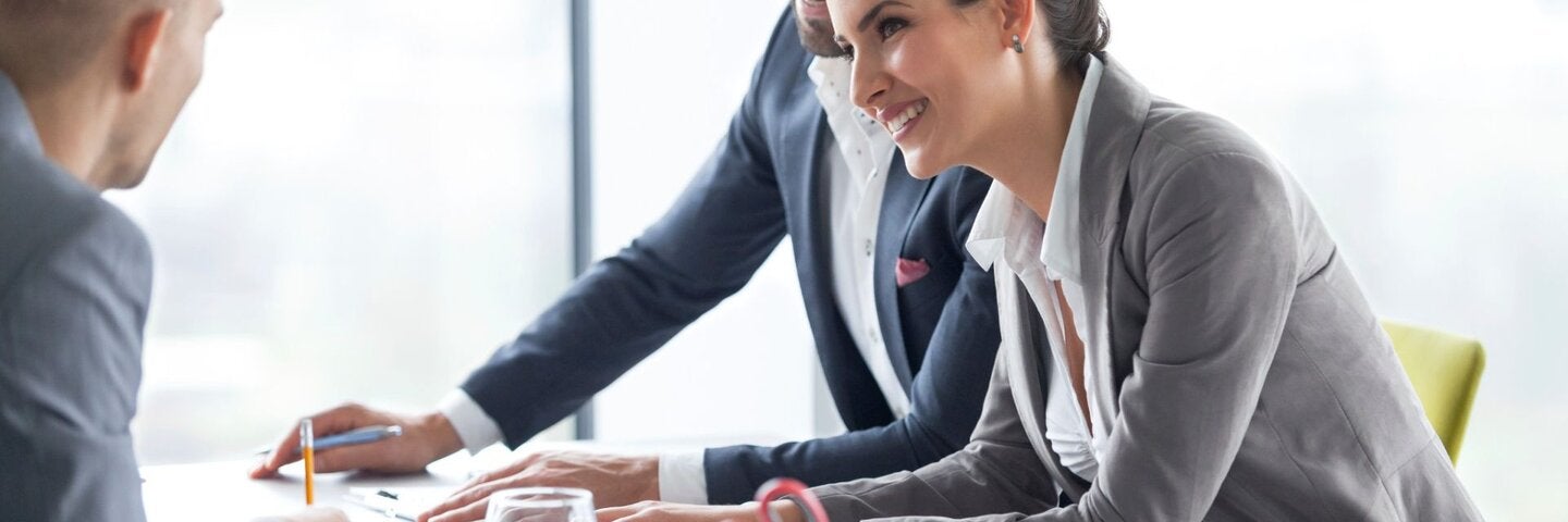 Business woman pointing out report in meeting.