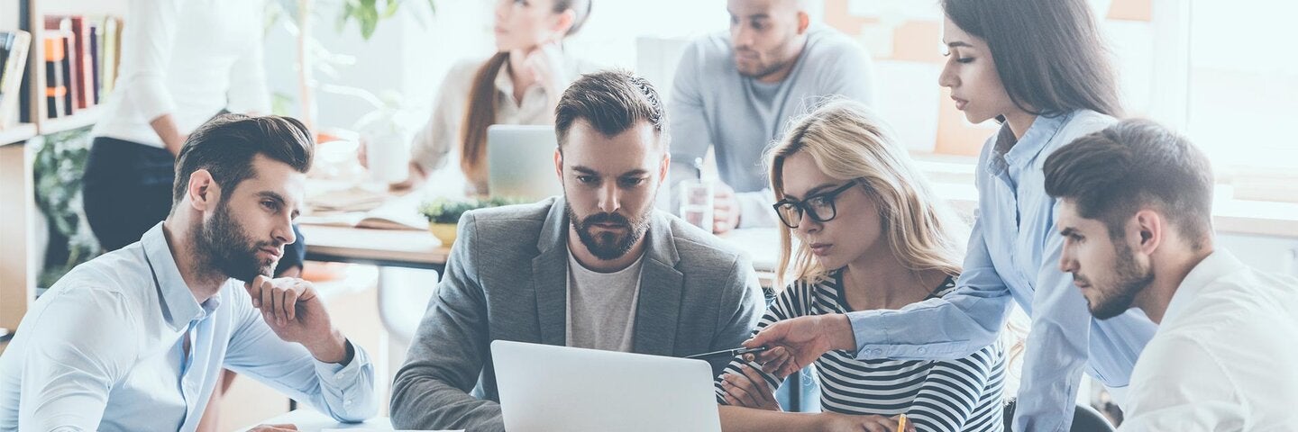 group of business men and women at meeting