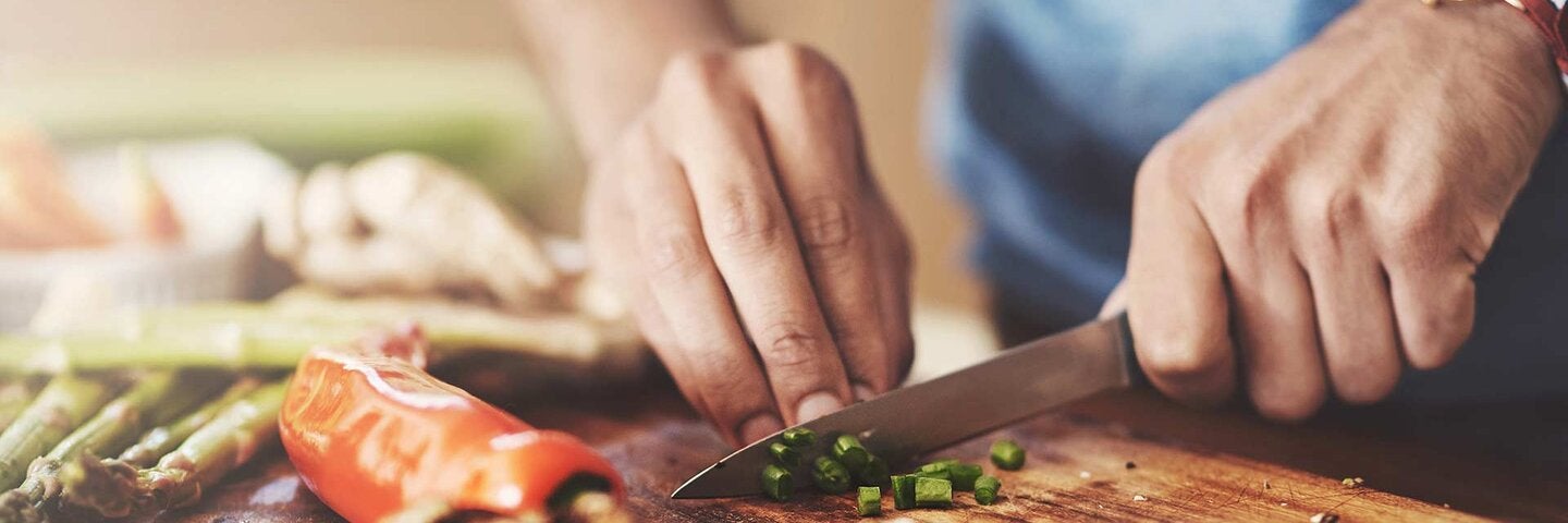 Cropped shot of a man preparing a healthy meal at home