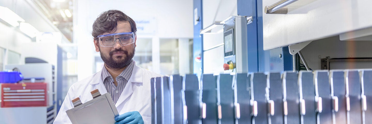 man checking on battery manufacturing processes