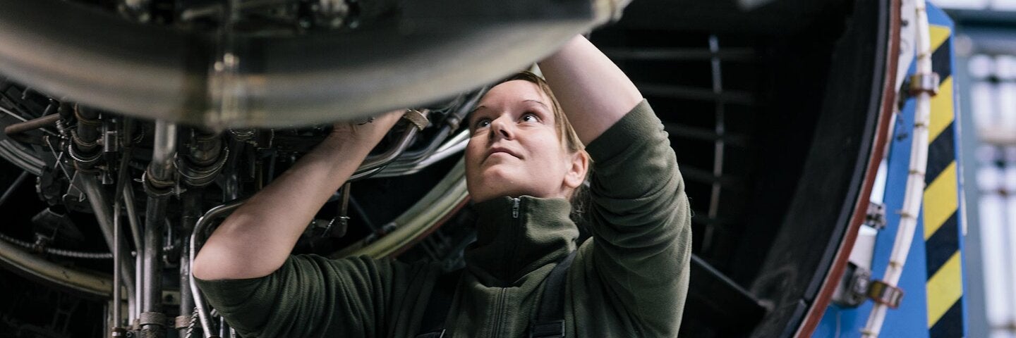 female mechanic working on an aircraft