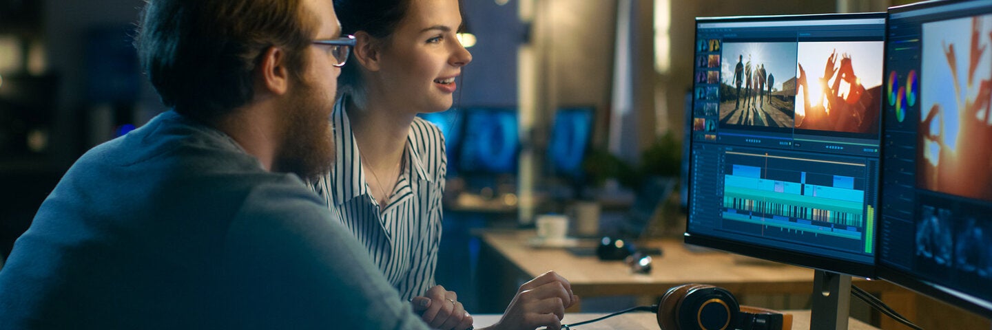 Man and woman editing video together