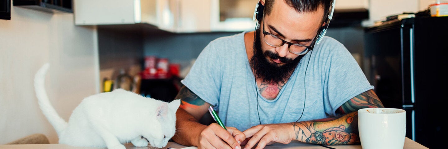 man writing with his cat