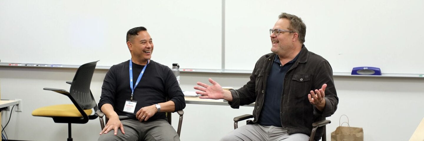 Mentor instructors sitting in a classroom talking