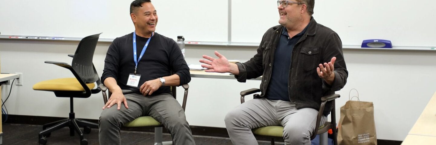 Mentor instructors sitting in a classroom talking