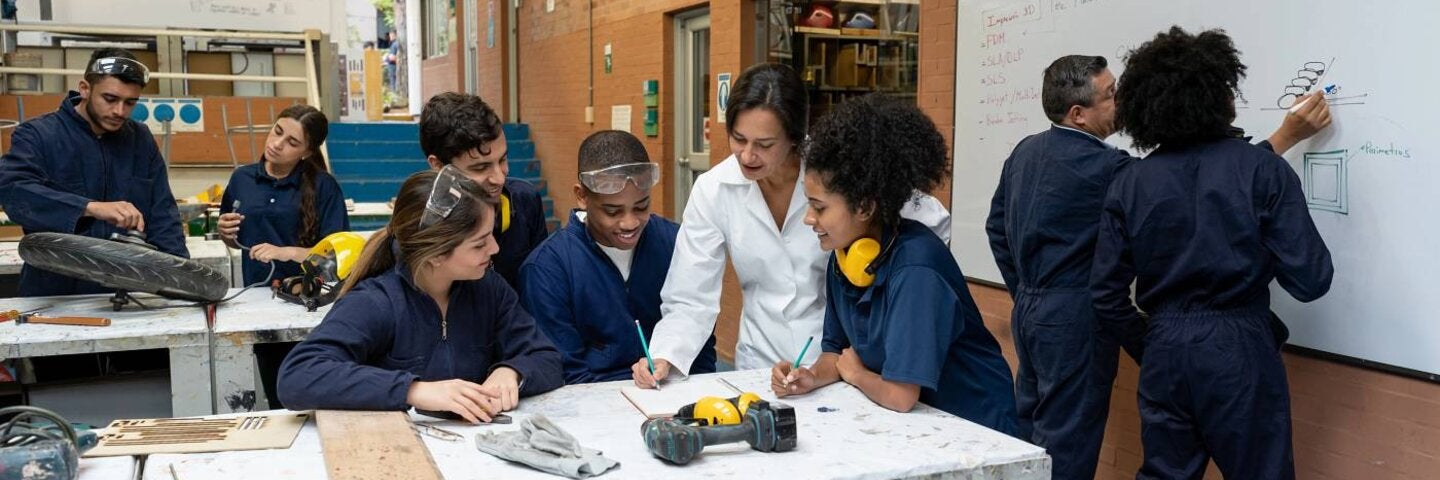 Group of students working with teachers at a workshop