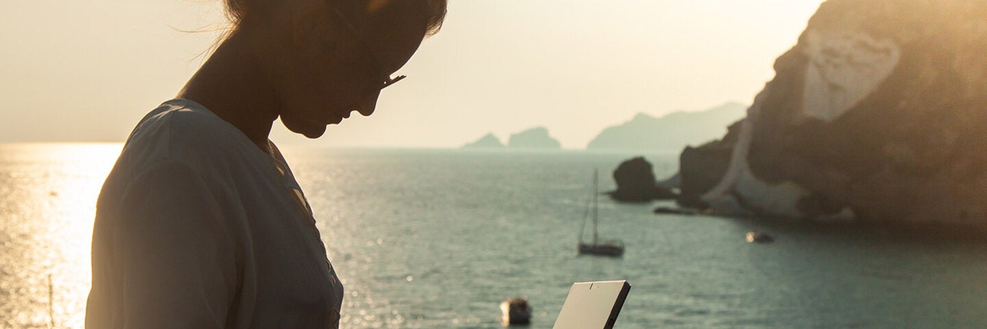 woman writing by the sea