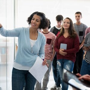 Teacher in classroom with white board
