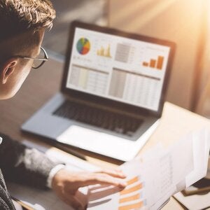 analyst looking at a computer screen while they work