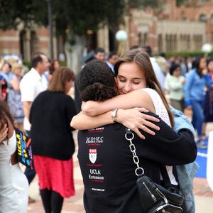graduate hugging one of their instructors